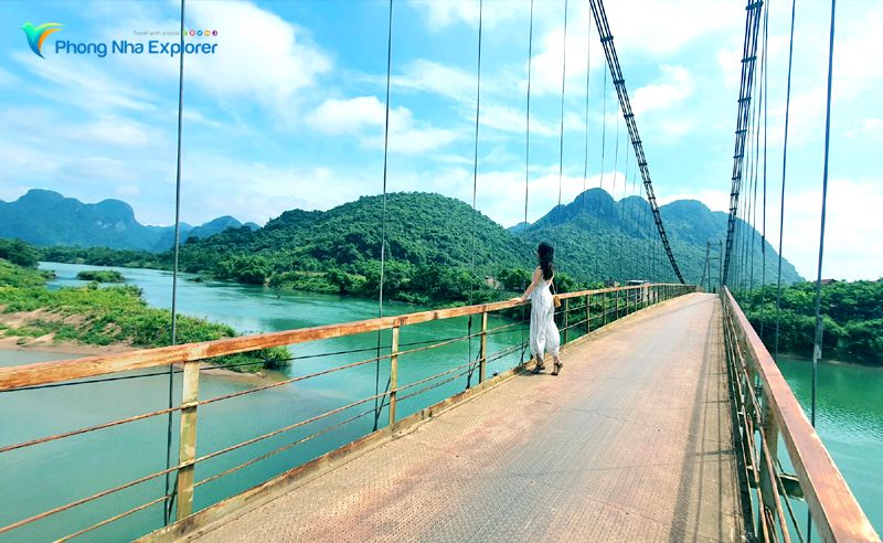 Teenagers enjoy taking pictures on the suspension bridge in Tram Me Phong Nha Village.